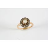 A DIAMOND CLUSTER RING the flowerhead design is set with an untested pearl within a surround of