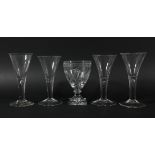 FOUR GEORGIAN WINE GLASSES, the trumpet bowl above a tear drop stem and conical foot, height 17cm