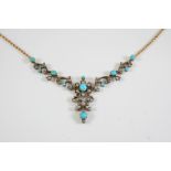 A TURQUOISE AND DIAMOND NECKLACE of foliate scrolling form, set with turquoise cabochons and