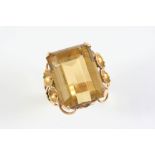 A CITRINE SINGLE STONE DRESS RING the large rectangular-shaped citrine is set within a gold openwork