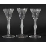 SET OF SIX WINE GLASSES, circa 1750, the pan topped, rounded funnel bowl with engraved floral band