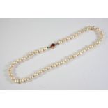 A SINGLE ROW BAROQUE CULTURED PEARL NECKLACE the baroque shaped pearls are set to a gold clasp