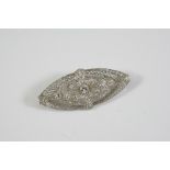 AN EDWARDIAN DIAMOND PLAQUE BROOCH the oval-shaped openwork design is set with three collet set