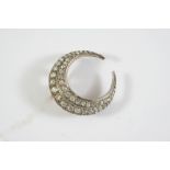 A VICTORIAN DIAMOND CLOSED CRESCENT BROOCH formed as two rows of graduated old cushion-shaped