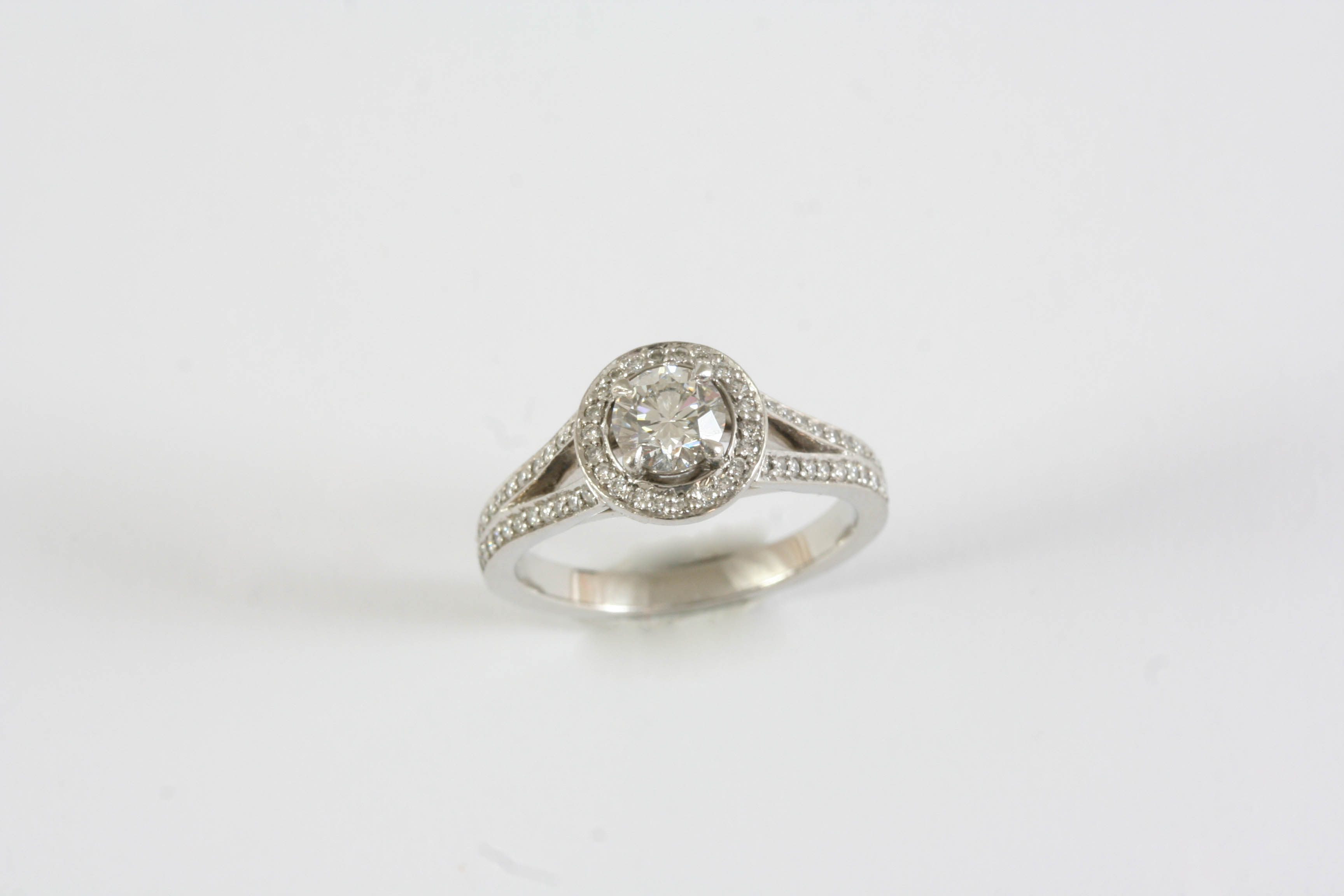 A DIAMOND CLUSTER RING BY MAPPIN & WEBB the round brilliant-cut diamond is set within a surround