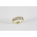 A DIAMOND FIVE STONE RING set with five graduated old circular diamonds, in yellow gold. Size O 1/2