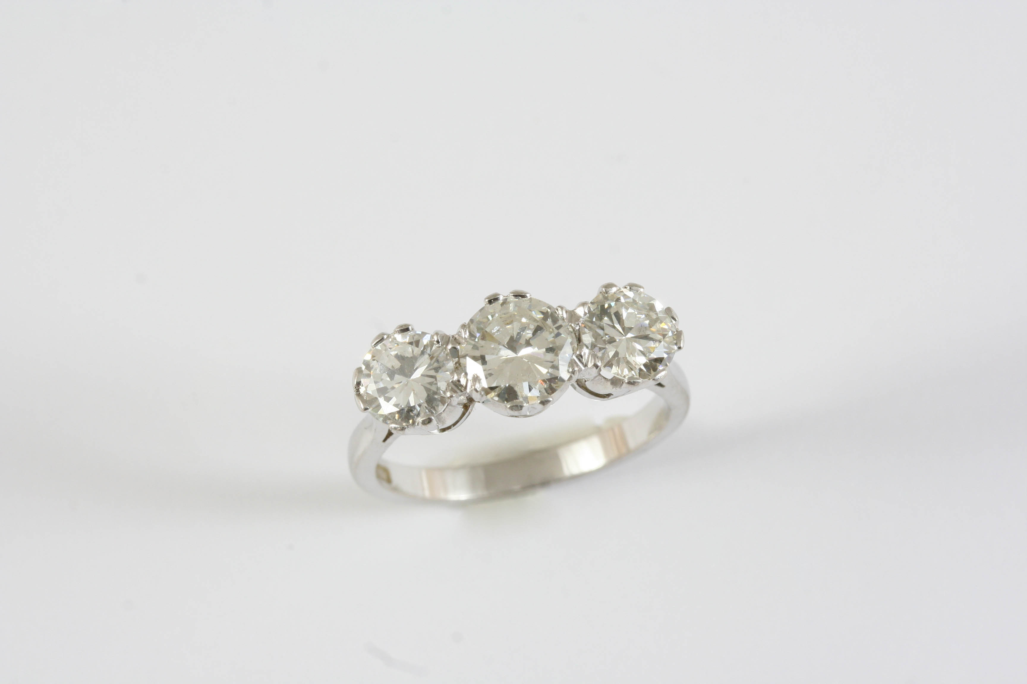 A DIAMOND THREE STONE RING the three graduated brilliant-cut diamonds are set in 18ct white gold.