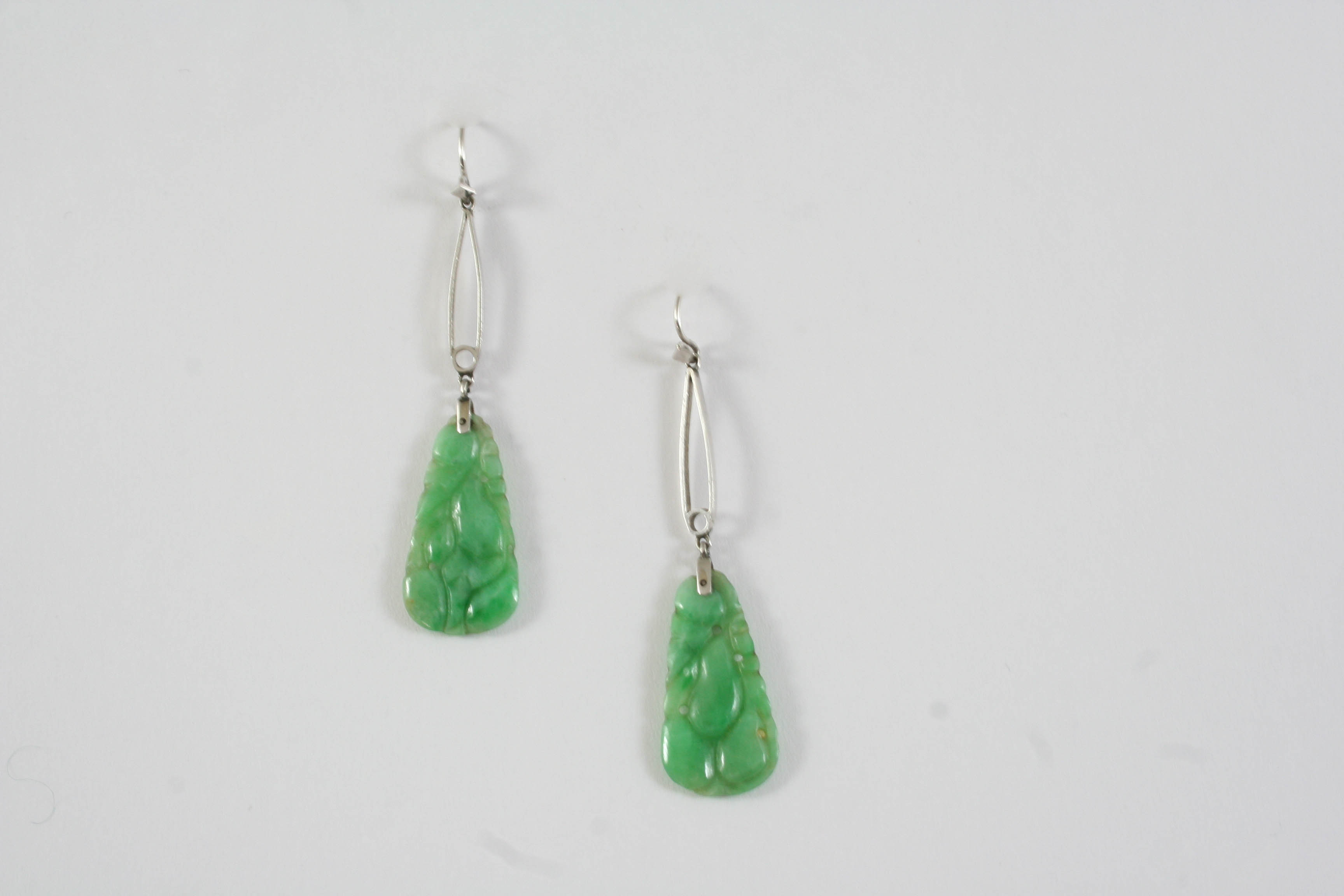 A PAIR OF JADE DROP EARRINGS with pierced and carved decoration, 5cm long