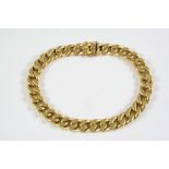 A 14CT GOLD FLAT CURB LINK BRACELET with concealed clasp, 21cm long, 24 grams