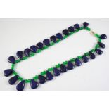 A SAPPHIRE AND EMERALD NECKLACE the emerald bead necklace suspends sapphire pear-shaped drops,