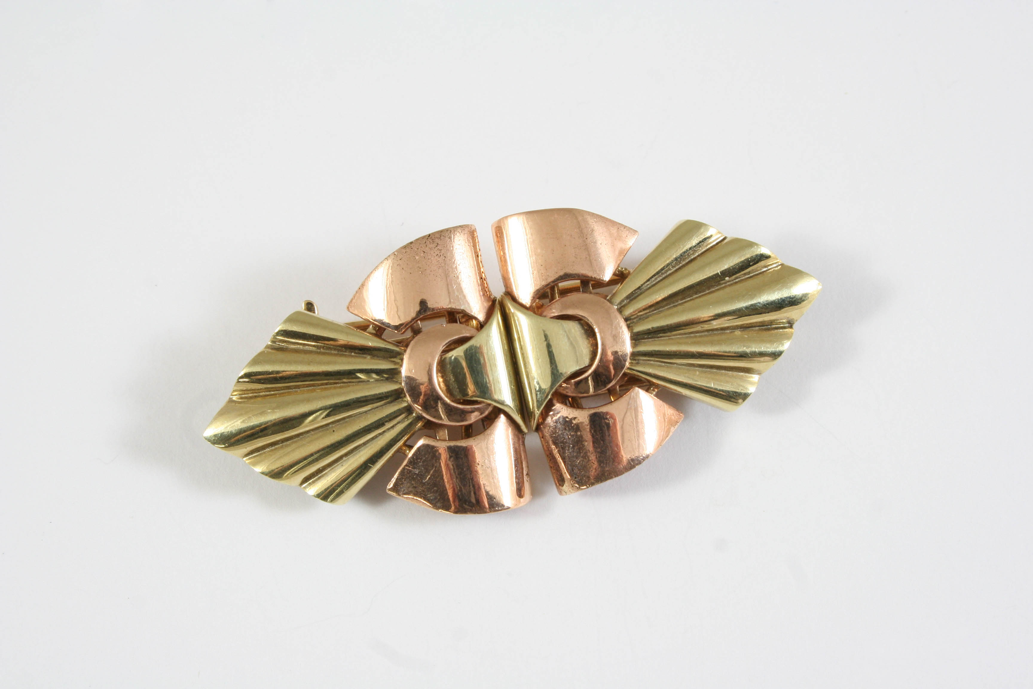 A TWO COLOUR GOLD DOUBLE CLIP BROOCH of geometric shape, the brooch divides to form two clips, 5.5cm