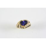 A SAPPHIRE AND DIAMOND CLUSTER RING the heart-shaped sapphire is set within a surround of calibre-