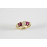 A RUBY AND DIAMOND FIVE STONE RING the two cushion-shaped rubies are set with three cushion-shaped
