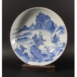 JAPANESE NABESHIMA DISH, blue painted with buildings and trees before a lake and mountains, the