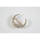 A VICTORIAN DIAMOND CLOSED CRESCENT BROOCH formed with graduated old brilliant-cut diamonds, in