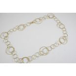 A GOLD NECKLACE formed as graduated interlocking gold circles, 59cm long, 19.1 grams