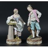 PAIR OF SAMSON FIGURES, late 19th century, he with a handful of coins, she with a basket of produce,