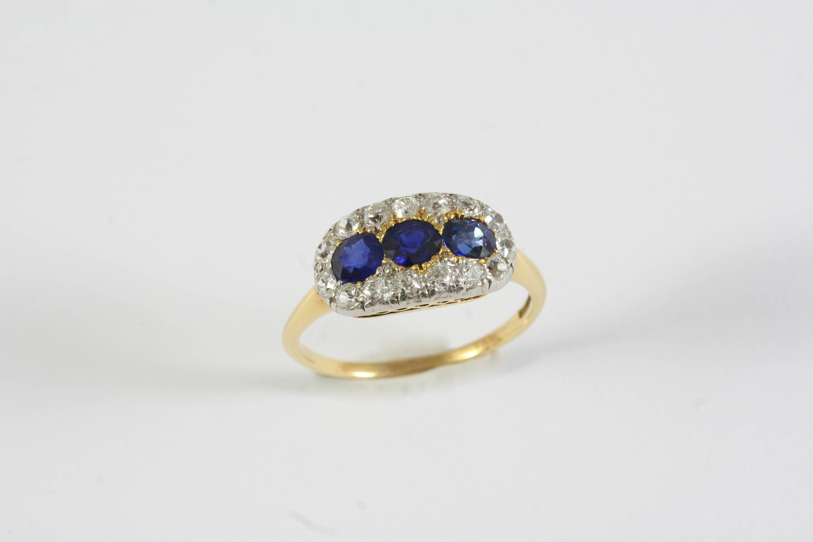 A LATE VICTORIAN SAPPHIRE AND DIAMOND TRIPLE CLUSTER RING the three circular-cut sapphires are set