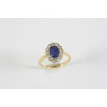 A SAPPHIRE AND DIAMOND CLUSTER RING the oval-shaped sapphire is set within a surround of thirteen