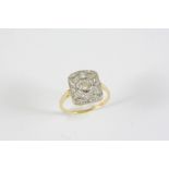 A DIAMOND CLUSTER RING the circular-cut diamond is set within an openwork surround of graduated