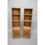 PAIR OF LIMED OAK BOOKCASES possibly by Heals, the narrow bookcases with two shelves and cupboard