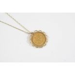 A GOLD EDWARD VII HALF SOVEREIGN 1907, in a gold pendant mount and on a 9ct gold fine link chain,