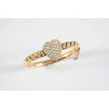 A GOLD AND PEARL SET HEART HALF HINGED BANGLE the heart motif set with graduated half pearls, with
