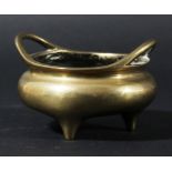 CHINESE CENSER, of circular form with two handles and three short feet, cast mask and characters