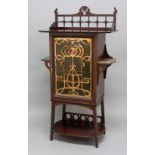 ART NOUVEAU MUSIC CABINET a mahogany cabinet, with a frosted glass door overlaid with copper mount