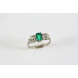 AN EMERALD AND DIAMOND THREE STONE RING the rectangular-shaped emerald is set with two old cushion-