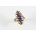 A SAPPHIRE AND DIAMOND MARQUISE-SHAPED CLUSTER RING the five graduated oval-shaped sapphires are set