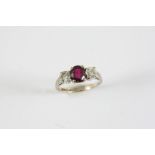 A RUBY AND DIAMOND THREE STONE RING the oval-shaped ruby is set with two round brilliant-cut