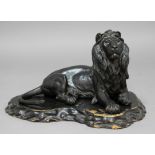 JAPANESE BRONZE LION, recumbent with his head raised, on a wooden plinth, signature seal to base,