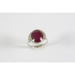 A RUBY AND DIAMOND RING the oval-shaped ruby weighs 6.21 carats and is set with graduated old