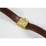 A SILVER GILT WRISTWATCH BY MUST DE CARTIER the signed rectangular-shaped dial with Roman