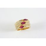 A RUBY AND DIAMOND RING formed as three diamond set rings, each mounted with a marquise-shaped ruby,