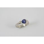 A SAPPHIRE AND DIAMOND RING the pear-shaped sapphire is set with a brilliant-cut diamond in 18ct