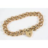 A 9CT GOLD CURB LINK BRACELET with padlock clasp, 19cm long, 36.6 grams