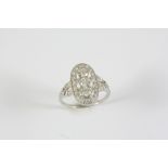 A DIAMOND CLUSTER RING the three collet set circular-cut diamonds are set within a surround of