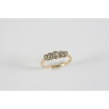 A DIAMOND FIVE STONE RING the five graduated cushion-shaped old cut diamonds are set in 18ct gold.