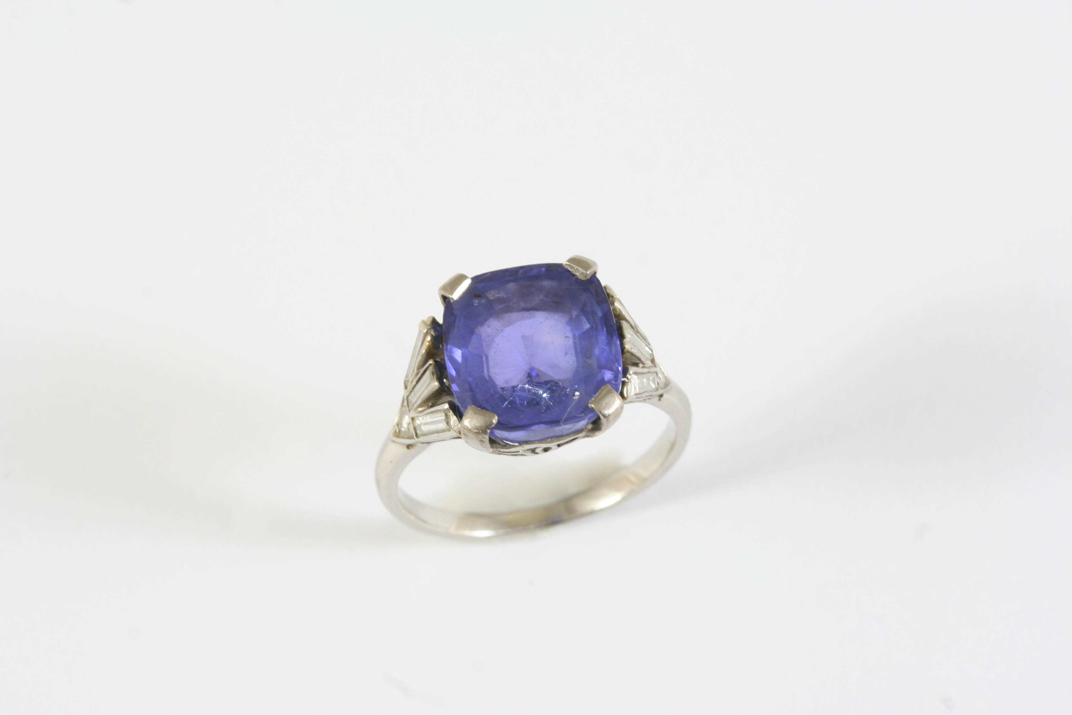 AN ART DECO SAPPHIRE AND DIAMOND RING the cushion-cut sapphire weighs approximately 5.8 carats and