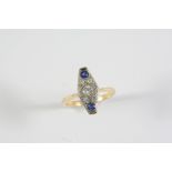 A SAPPHIRE AND DIAMOND CLUSTER RING the circular-cut diamond is set within a surround millegrain set