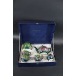 MOORCROFT - BOXED FINCHES GREEN TEA SET a boxed tea set comprising a teapot, milk jug and sugar