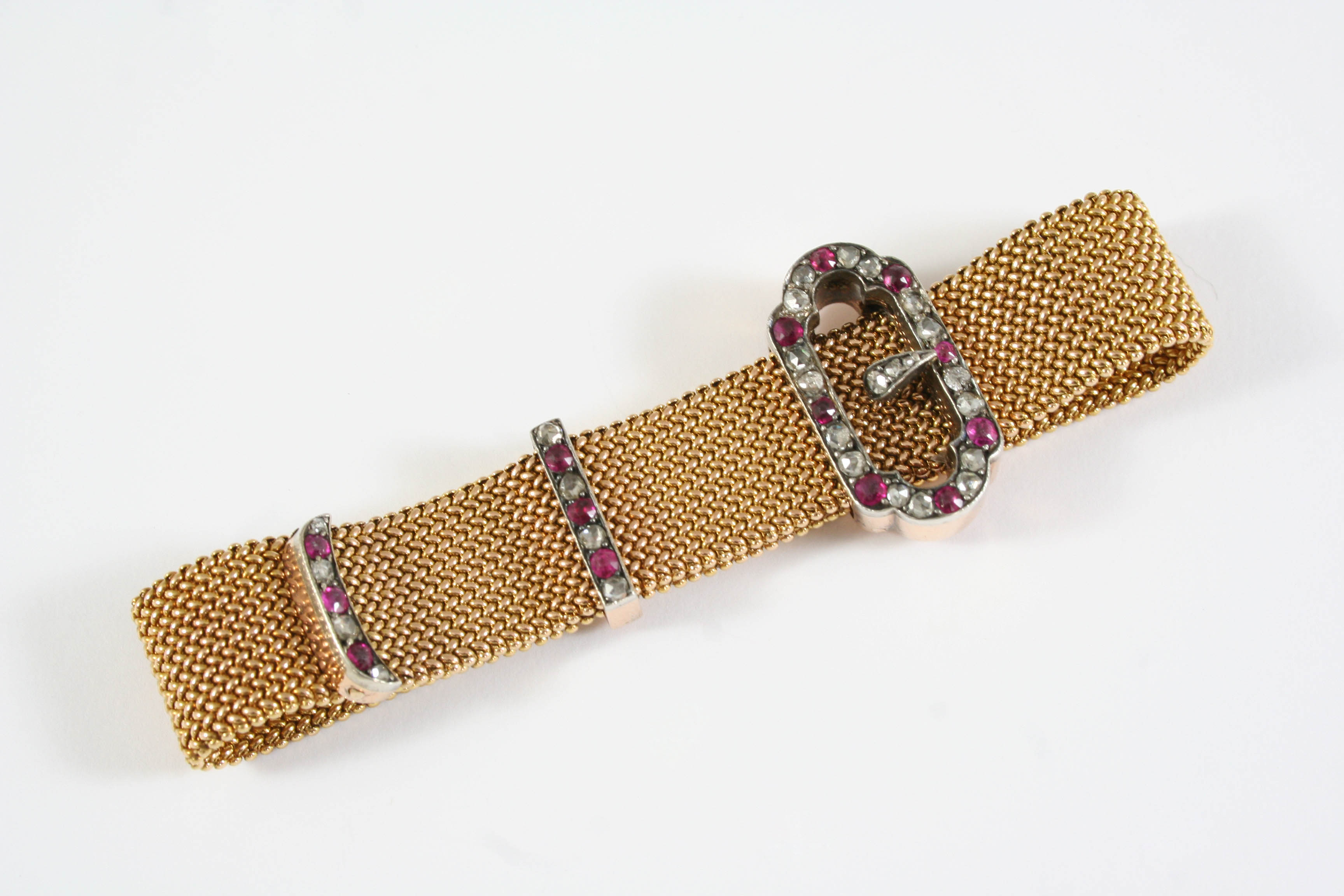 A GOLD, RUBY AND DIAMOND BUCKLE BRACELET the gold mesh bracelet is mounted with a buckle set with