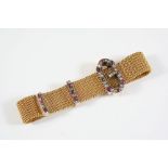 A GOLD, RUBY AND DIAMOND BUCKLE BRACELET the gold mesh bracelet is mounted with a buckle set with