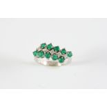 AN EMERALD AND DIAMOND THREE ROW RING the row of circular-cut diamonds is set between two rows of