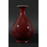 CHINESE SANG DE BOEUF VASE, Qianlong mark but probably later, of baluster form, red shading to cream