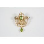 AN EDWARDIAN PERIDOT AND PEARL BROOCH the openwork design is set with an octagonal-shaped peridot