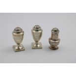 A PAIR OF GEORGE III VASE-SHAPED PEPPER CASTERS on square pedestal bases with shallow fluting and