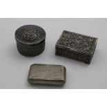 THREE INDIAN BOXES:- An embossed circular example with a pull-off cover, a rectangular tobacco box